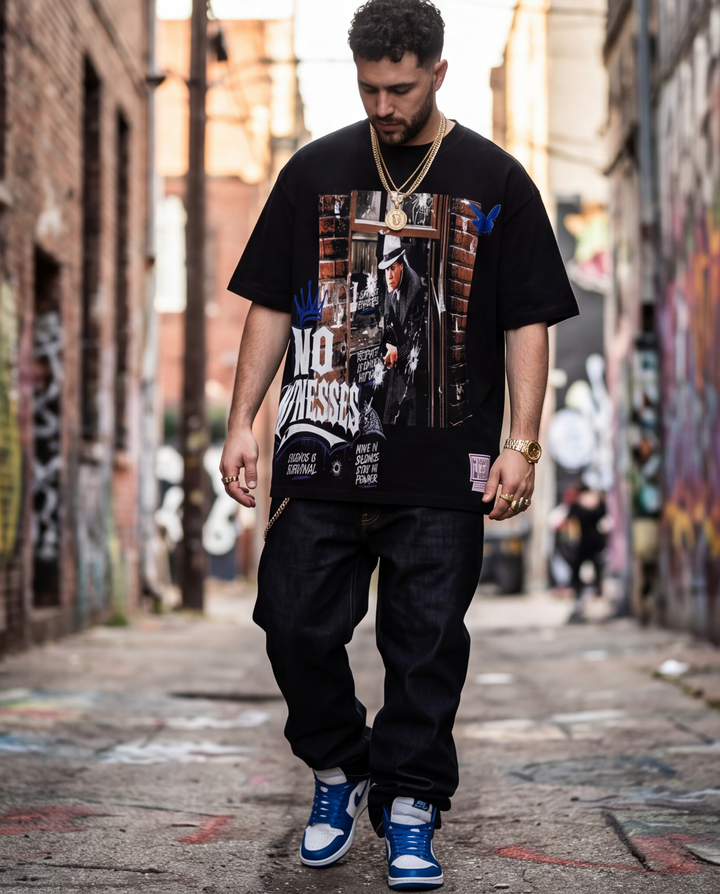 Full-length front view showing the boxy, oversized streetwear fit and thick collar of the 7oz black "No Witness" graphic tee.