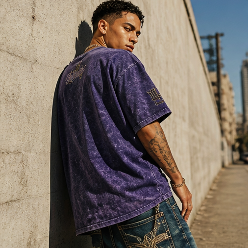 Side profile view of the Demmi Godz oversized purple streetwear t-shirt highlighting the dropped shoulder seams and relaxed sleeve fit.
