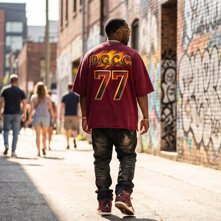 Back view of the burgundy oversized cropped t-shirt, showing the clean, minimalist design, dropped shoulder seams, and the unique distressed detailing along the bottom hem.