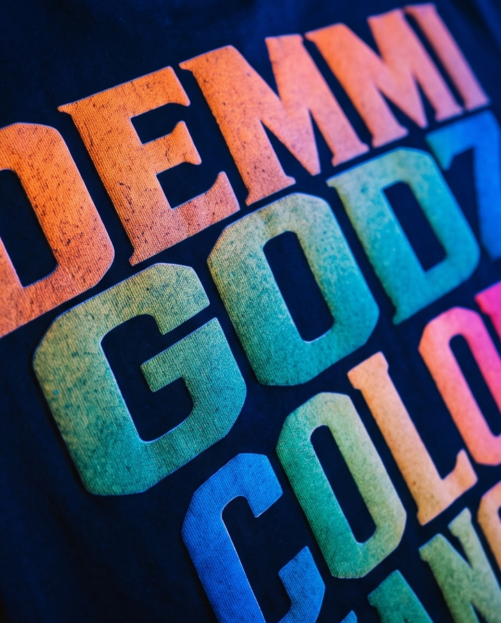 Detailed closeup of thick printed graphic on a premium black streetwear tee.